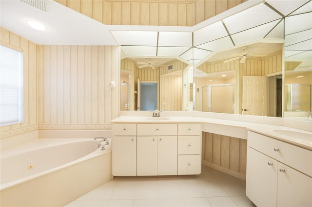 bathroom featuring ceiling fan, plus walk in shower, tile patterned floors, and dual vanity