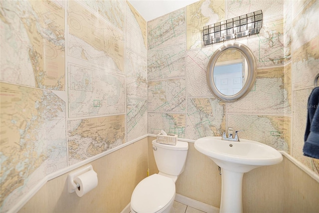 half bathroom with toilet and tile walls