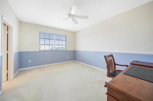 unfurnished office featuring ceiling fan and light carpet