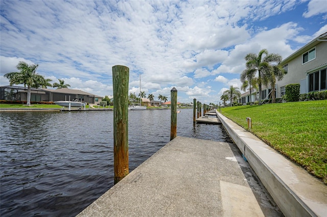 dock area featuring a yard and a water view