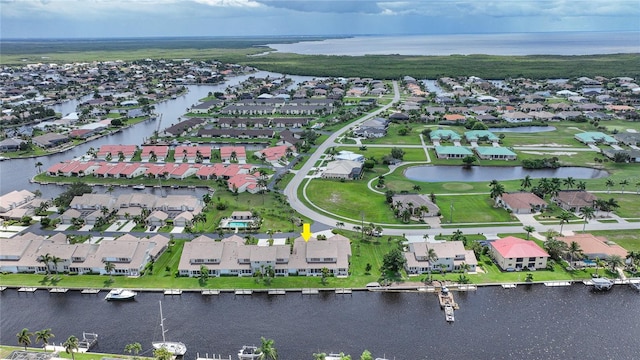 drone / aerial view featuring a water view and a residential view