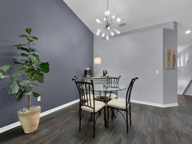 dining area featuring hardwood / wood-style flooring, high vaulted ceiling, and a chandelier