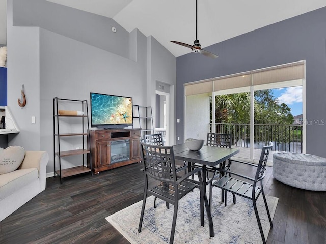 dining space with ceiling fan, high vaulted ceiling, and wood-type flooring