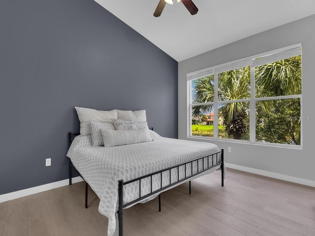 bedroom featuring light wood-type flooring, ceiling fan, and lofted ceiling