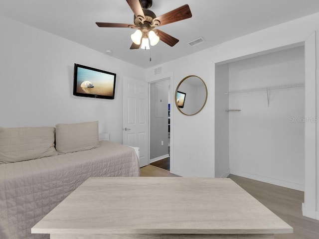 bedroom with a closet, ceiling fan, and wood-type flooring