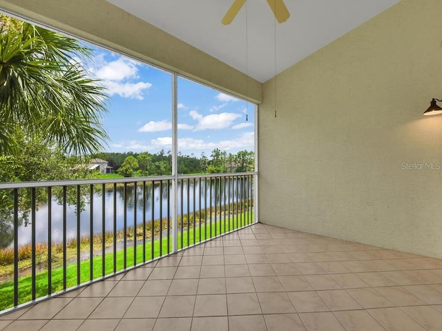 exterior space with ceiling fan and a water view