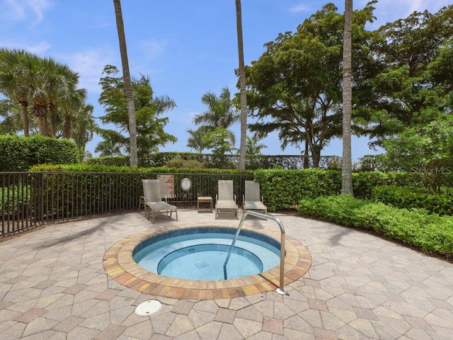 view of pool featuring a community hot tub and a patio