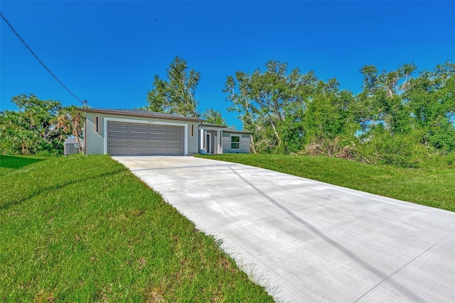 single story home with a garage and a front lawn