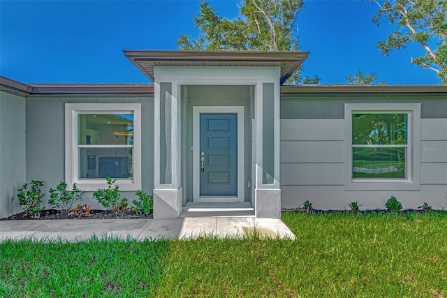 property entrance with a yard