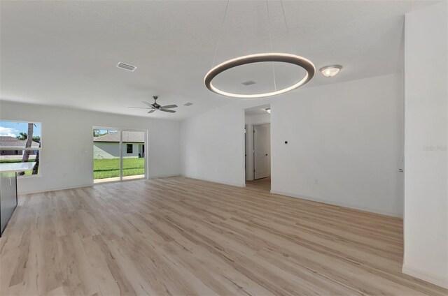4582 Enid Ln, North Port, FL 34288 - unfurnished living room featuring light wood finished floors, a ceiling fan, and baseboards