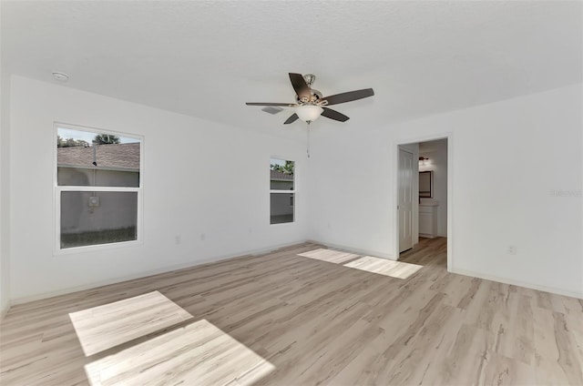 unfurnished room with ceiling fan, a healthy amount of sunlight, and light hardwood / wood-style floors