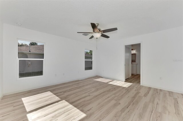 4582 Enid Ln, North Port, FL 34288 - unfurnished room featuring light wood finished floors, a ceiling fan, and baseboards