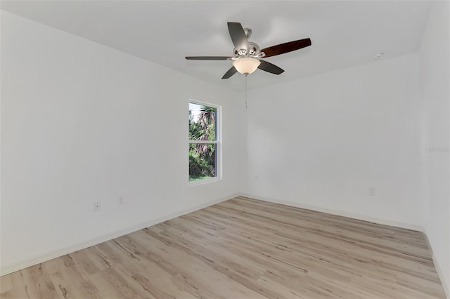 empty room with ceiling fan and light hardwood / wood-style flooring