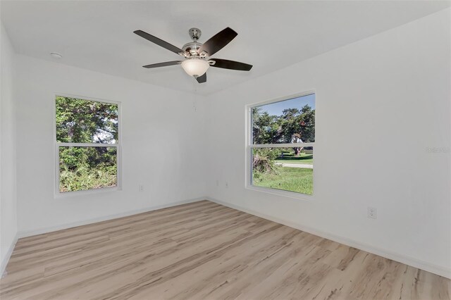 4582 Enid Ln, North Port, FL 34288 - unfurnished room featuring plenty of natural light, wood finished floors, and baseboards