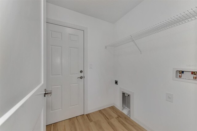 4582 Enid Ln, North Port, FL 34288 - laundry room with electric dryer hookup, hookup for a washing machine, light wood-style flooring, and baseboards