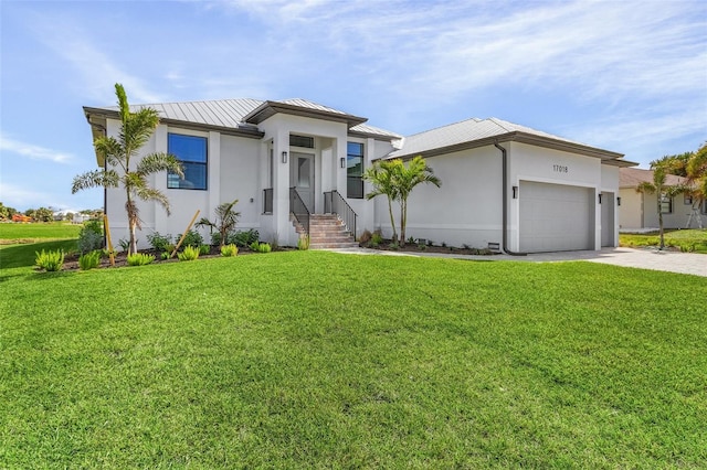 view of front of home featuring a front yard and a garage