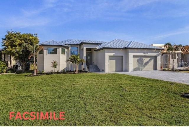 prairie-style home featuring an attached garage, decorative driveway, a front yard, and stucco siding