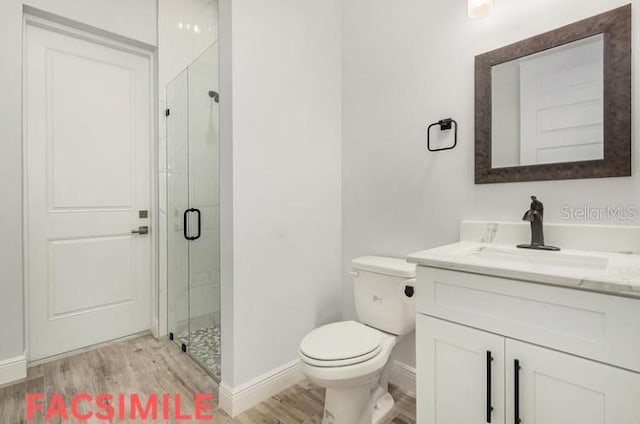 bathroom featuring walk in shower, toilet, vanity, and wood-type flooring