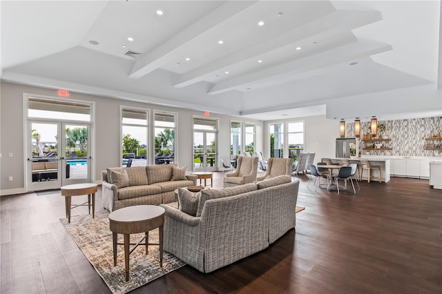 living area featuring recessed lighting, dark wood-style flooring, visible vents, beamed ceiling, and a raised ceiling