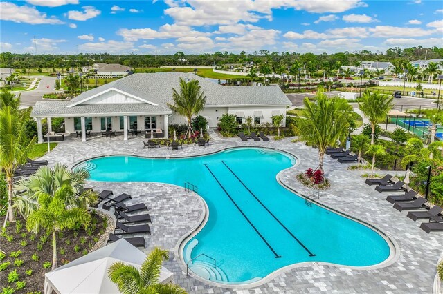 16423 Bridle Ridge St, Port Charlotte, FL 33953 - community pool featuring a patio area and view of wooded area