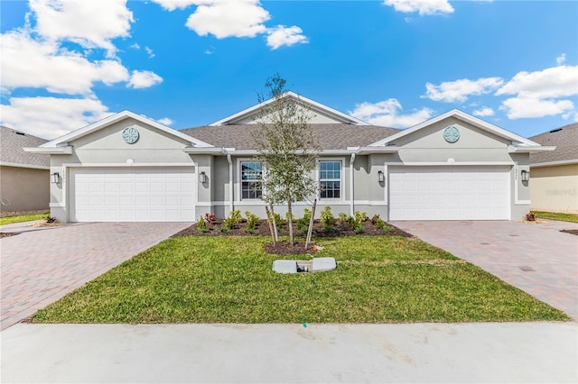 single story home featuring a garage, a front lawn, decorative driveway, and stucco siding