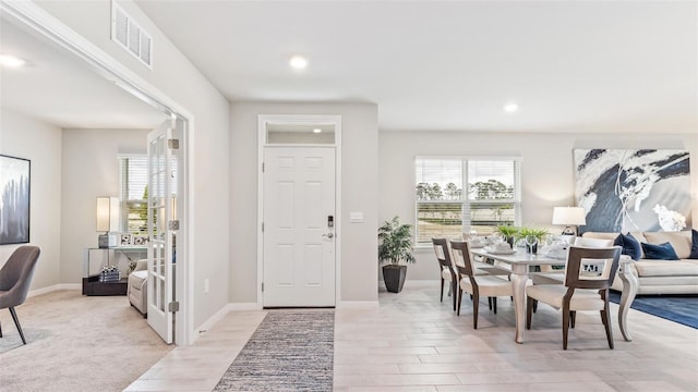 foyer entrance featuring recessed lighting, baseboards, visible vents, and light wood finished floors