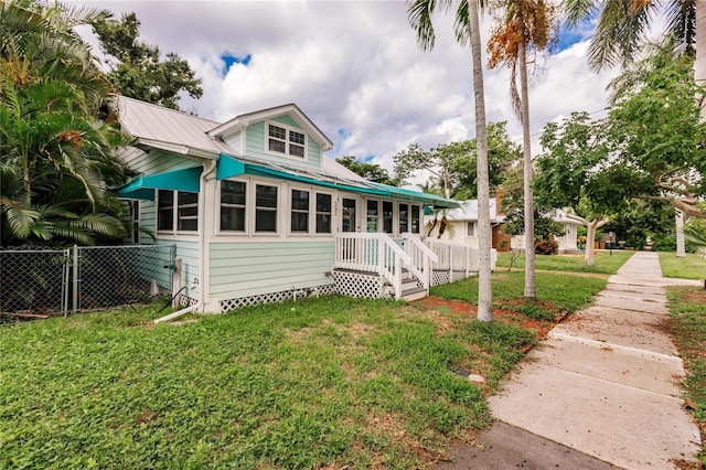 rear view of property with a yard