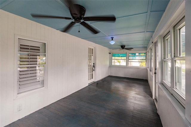 unfurnished sunroom featuring ceiling fan