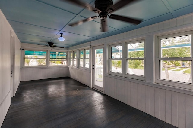 unfurnished sunroom featuring ceiling fan