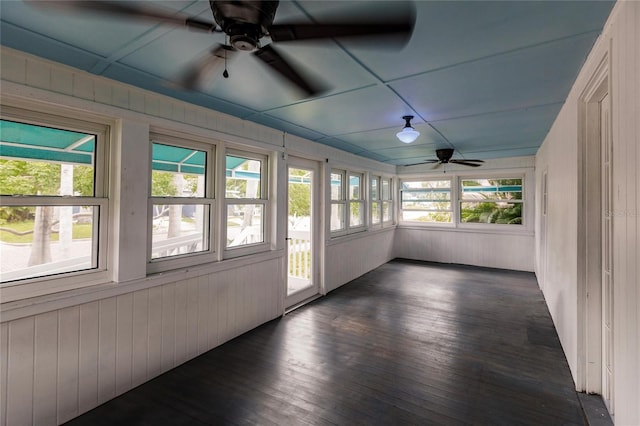 unfurnished sunroom featuring ceiling fan