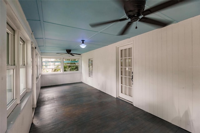 unfurnished sunroom with ceiling fan