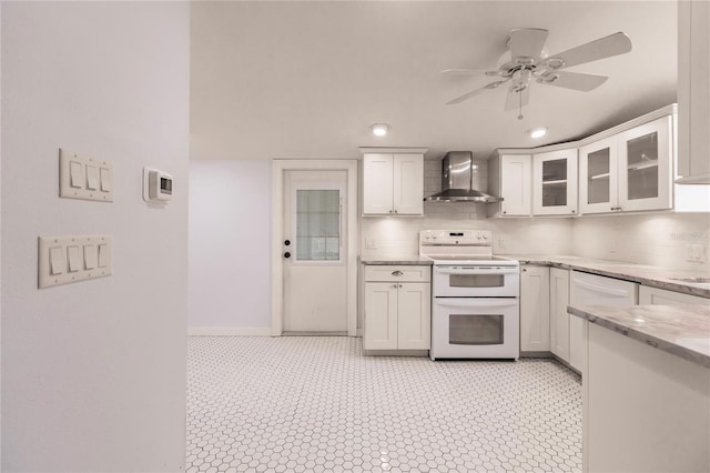 kitchen with white cabinetry, wall chimney exhaust hood, white electric stove, light tile patterned floors, and ceiling fan