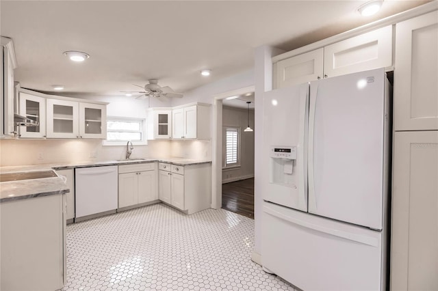 kitchen with a wealth of natural light, white appliances, ceiling fan, and light tile patterned flooring