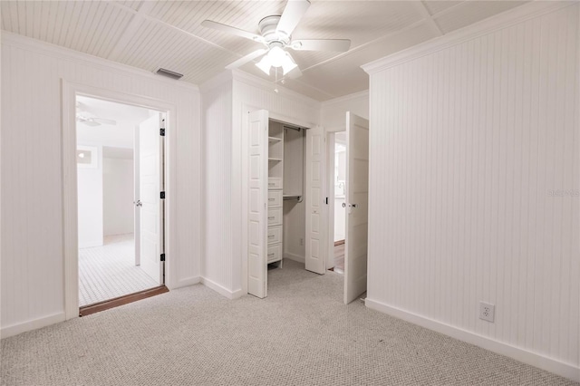 unfurnished bedroom with ceiling fan, a closet, and light carpet