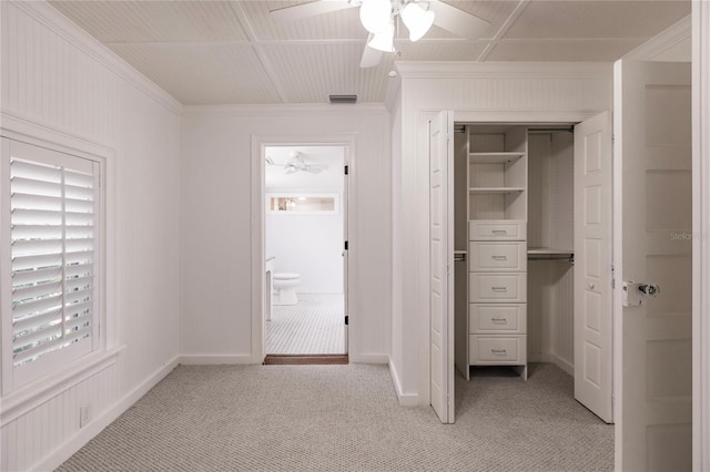 unfurnished bedroom with ceiling fan, a closet, and light carpet