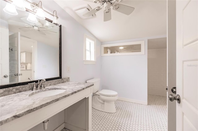 bathroom with ceiling fan, toilet, vanity, tile patterned floors, and vaulted ceiling