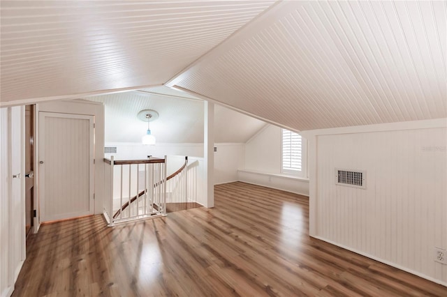 additional living space featuring hardwood / wood-style floors and lofted ceiling