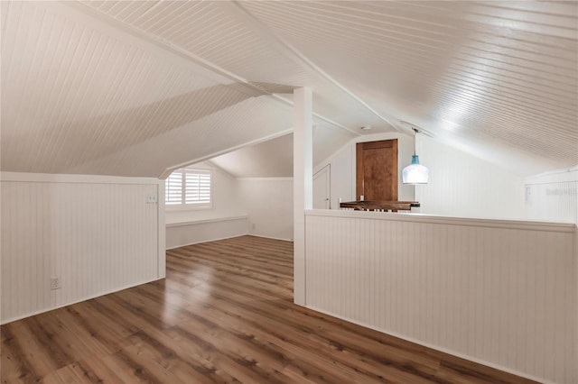 additional living space featuring vaulted ceiling and wood-type flooring