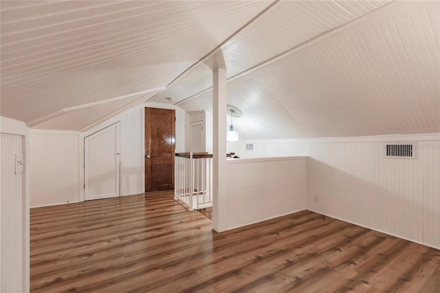 additional living space featuring hardwood / wood-style flooring and lofted ceiling