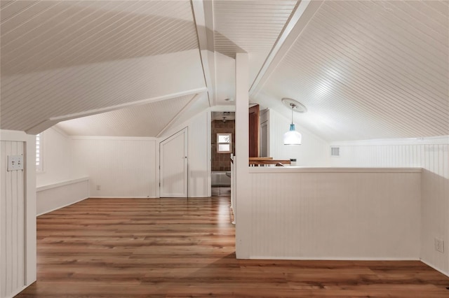 additional living space featuring hardwood / wood-style flooring and vaulted ceiling