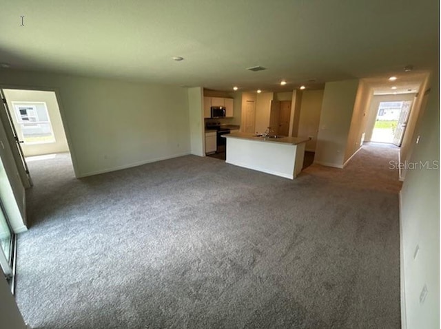 unfurnished living room featuring carpet flooring