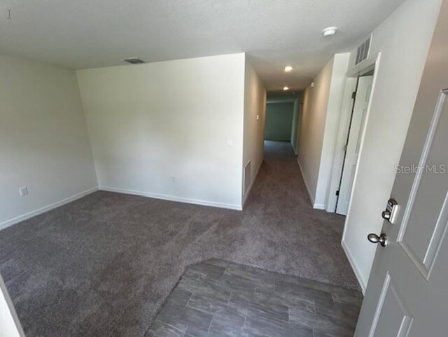 unfurnished room featuring carpet