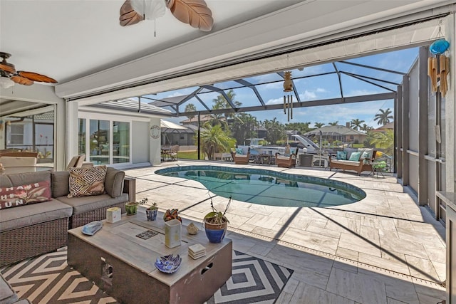 view of swimming pool with ceiling fan, a patio area, outdoor lounge area, and a lanai