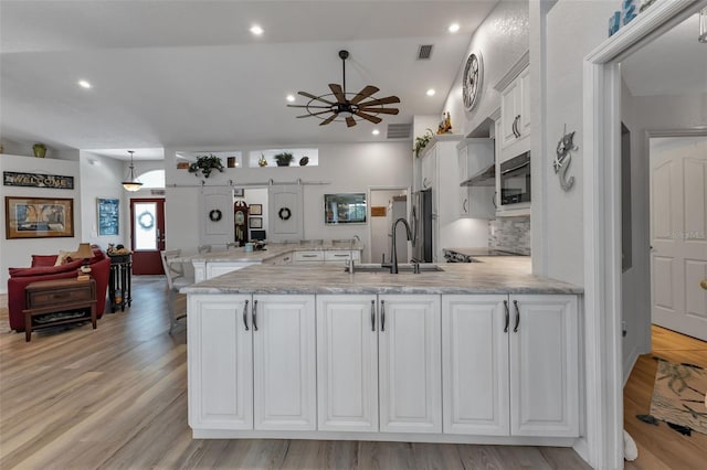 kitchen with ceiling fan, light wood-type flooring, and white cabinetry