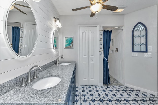 bathroom with ceiling fan, tile patterned flooring, and dual vanity