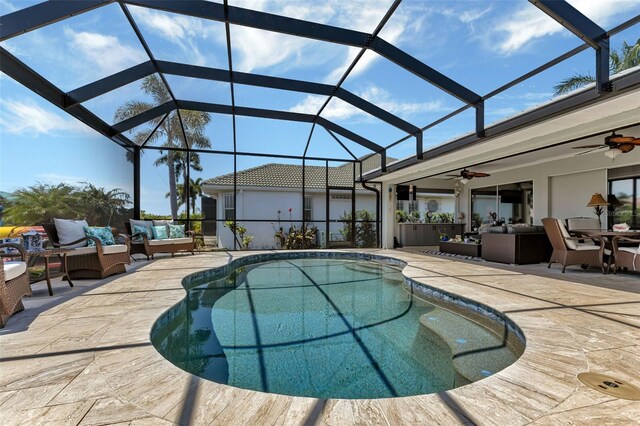 view of swimming pool featuring ceiling fan, an outdoor hangout area, and a lanai