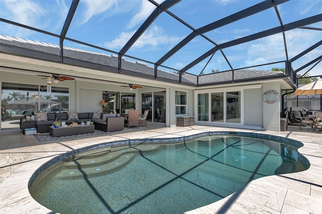 view of swimming pool with ceiling fan, a lanai, and outdoor lounge area