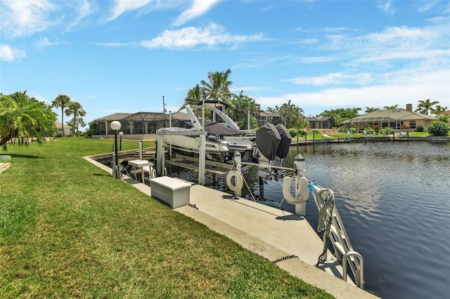 dock area with a lawn and a water view