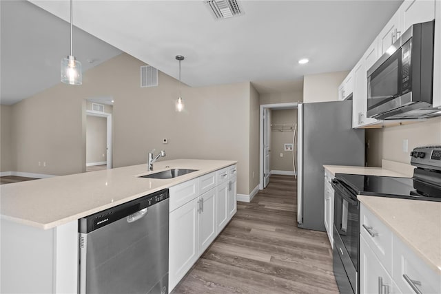 kitchen featuring hanging light fixtures, white cabinetry, sink, and appliances with stainless steel finishes