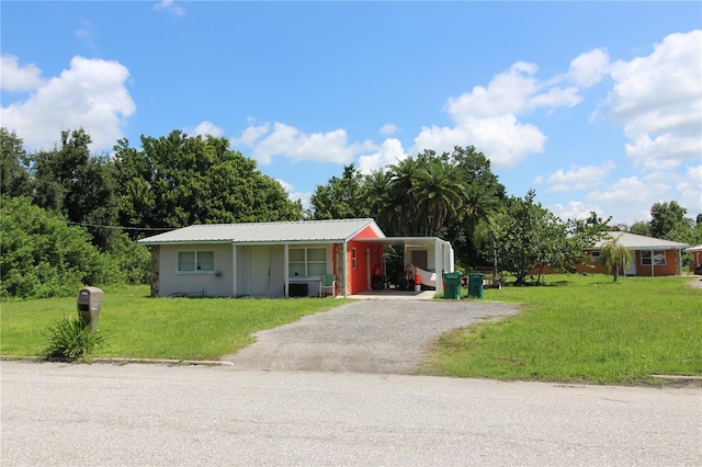 ranch-style house with a front yard and a carport